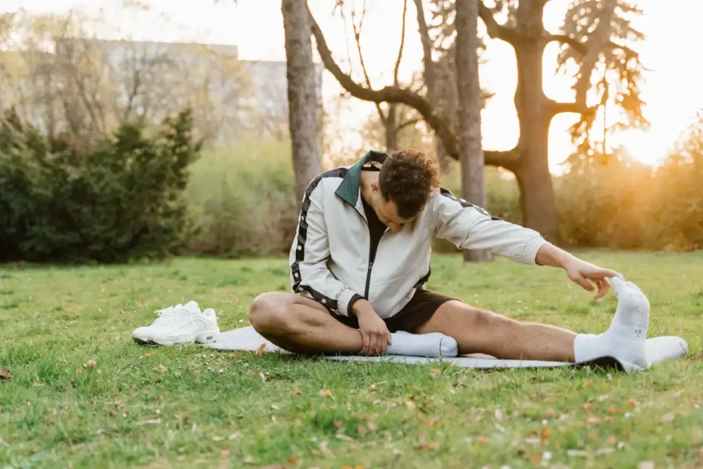 a man doing some stretching and meditation outdoor near riverside california