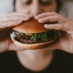 overeating, food addiction, woman eating burger
