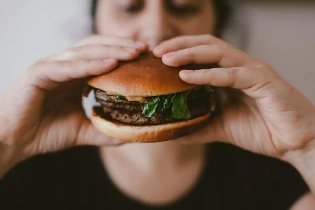 overeating, food addiction, woman eating burger