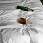 wine glass and alcohol in the bed