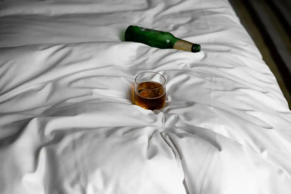 wine glass and alcohol in the bed