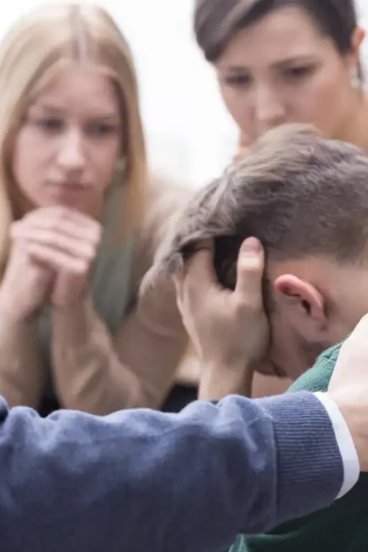 a young man with some family members feeling down and sad during an intervention