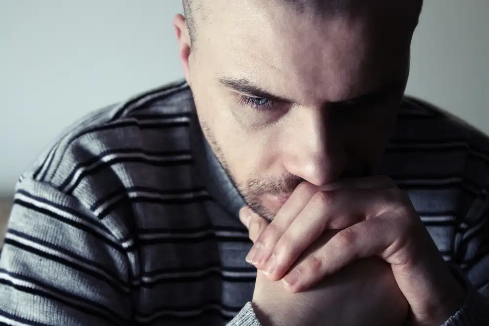 a thoughtful man thinking how to beat boredom to maintain addiction recovery