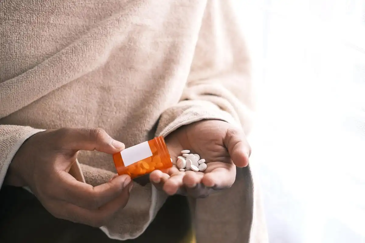 photo of a person taking pain killers