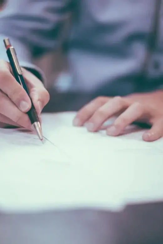 photo of a man writing on a paper creating financial plan