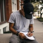 man writing in a gratitude journal
