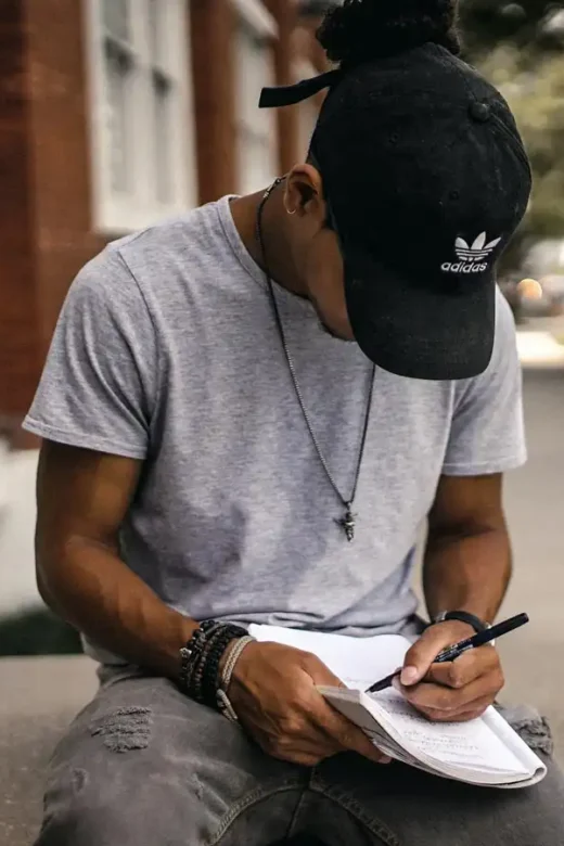 man writing in a gratitude journal