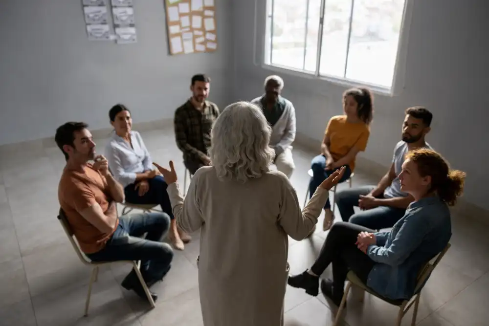 men and women in circle during a group therapy
