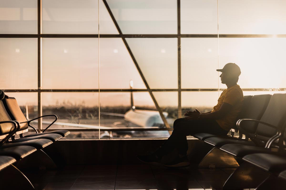 photo of a man sittin in the waiting area inside an airport