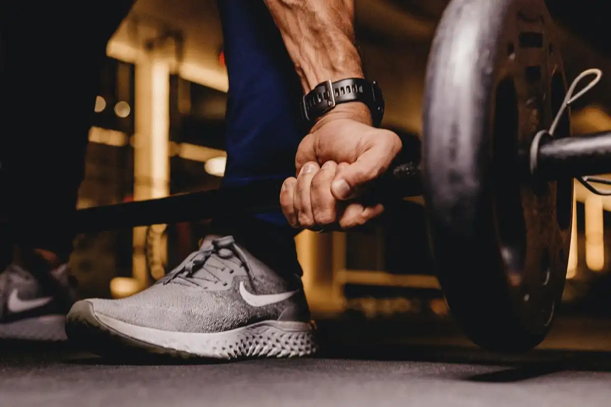 photo of a man lifting weights at the gym