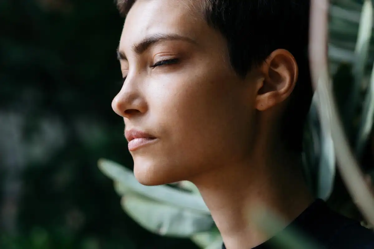 photo of a woman meditating in the forest