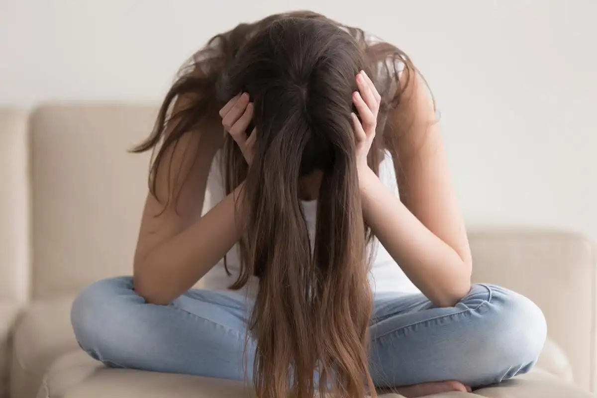 photo of a stressed woman sitting on the sofa