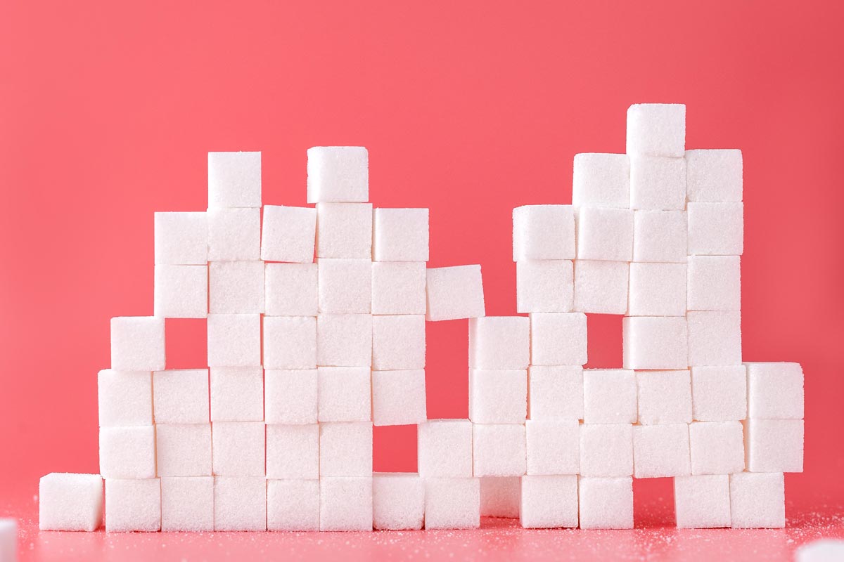 photo of sugar cubes on pink background