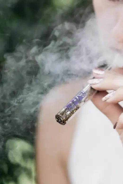 a photo of a lady with marijuana addiction smoking pot