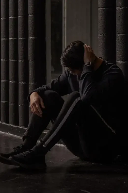 photo of a depressed man sitting on the floor