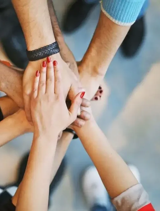 Hands coming together representing teamwork.