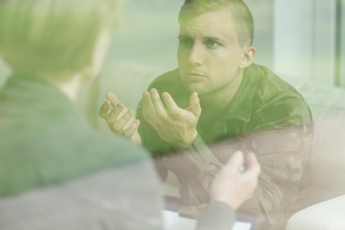 photo of psychologist and a soldier with PTSD