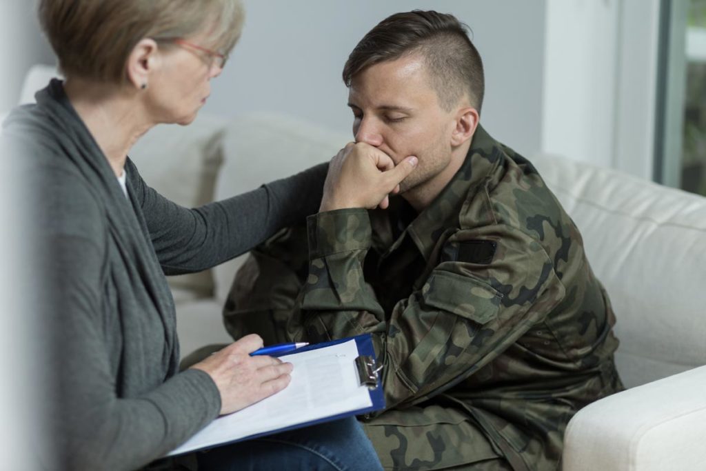 photo of psychologist and despair soldier with PTSD