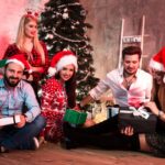 Picture showing group of friends with Christmas presents on party at home