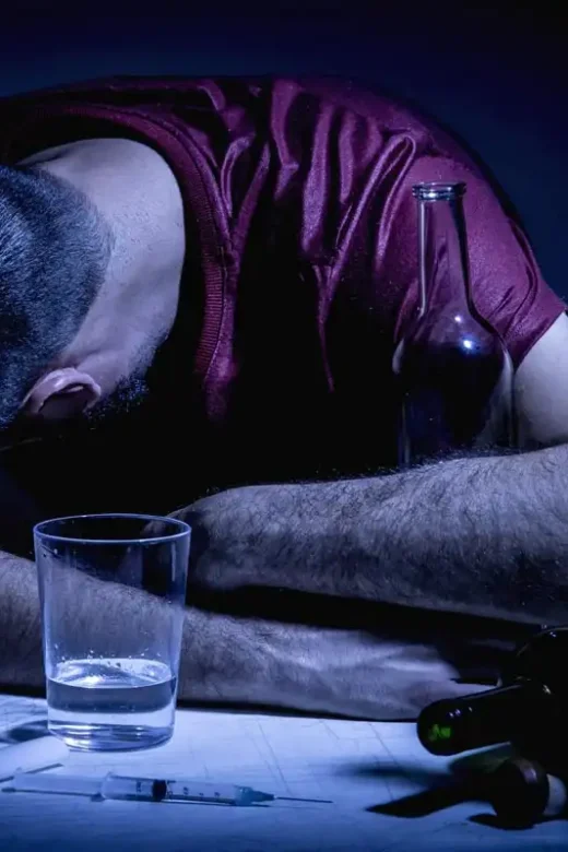 Young man with beard, lost in the vices of alcoholism, smoking and drug addiction