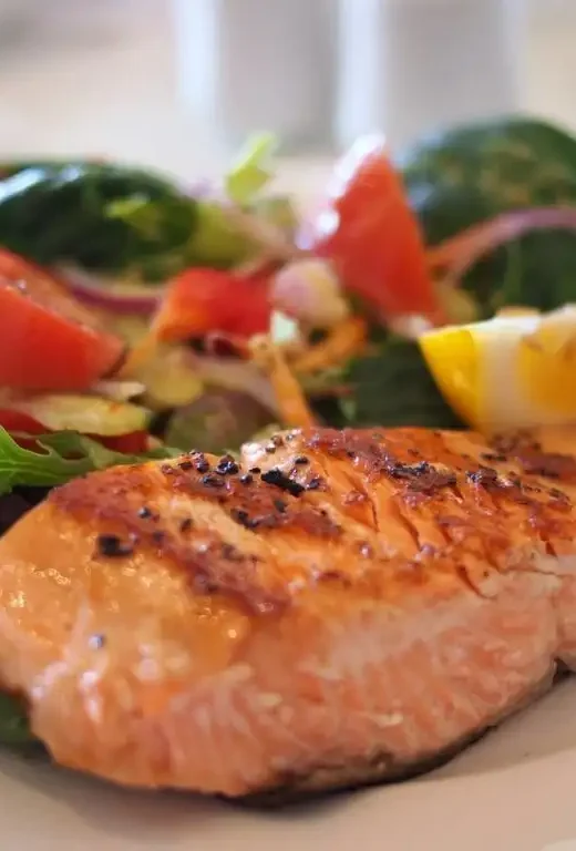 cooked Salmon and a salad on a plate