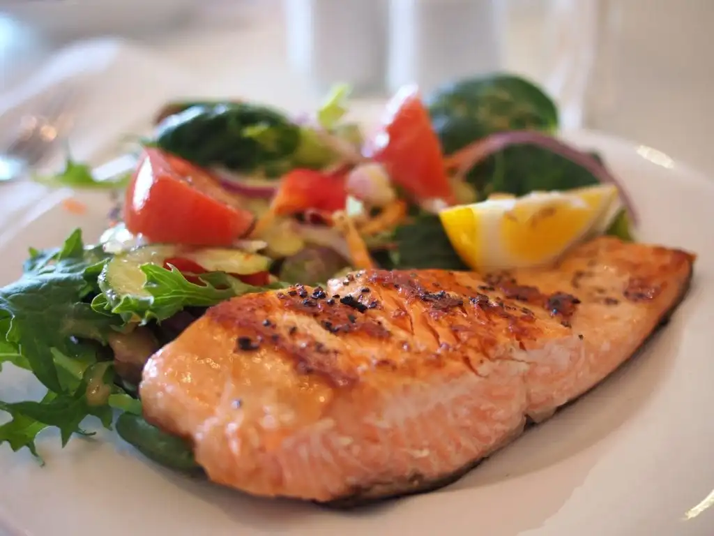 cooked Salmon and a salad on a plate