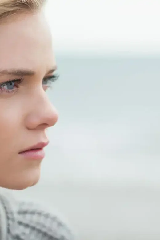 photo of a close up side view of a courageous woman on the beach