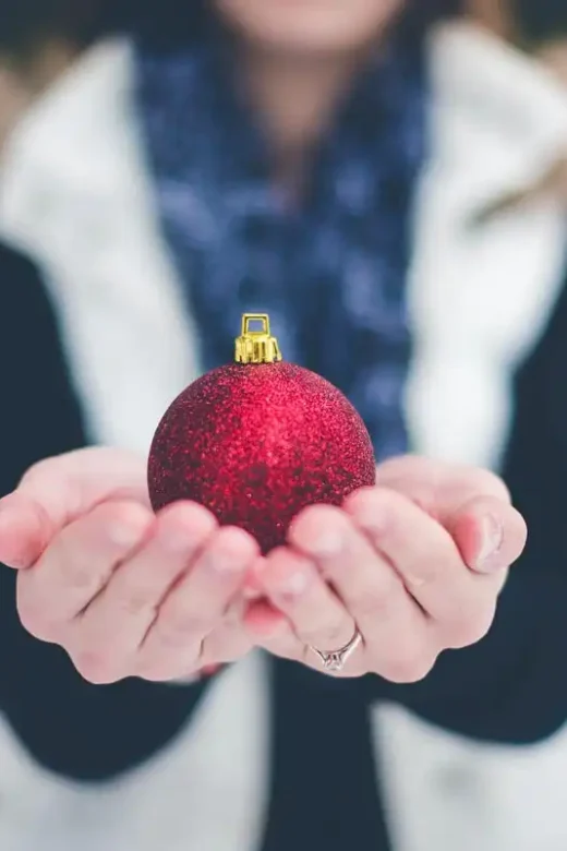 photo of a woman holding a christmas ball