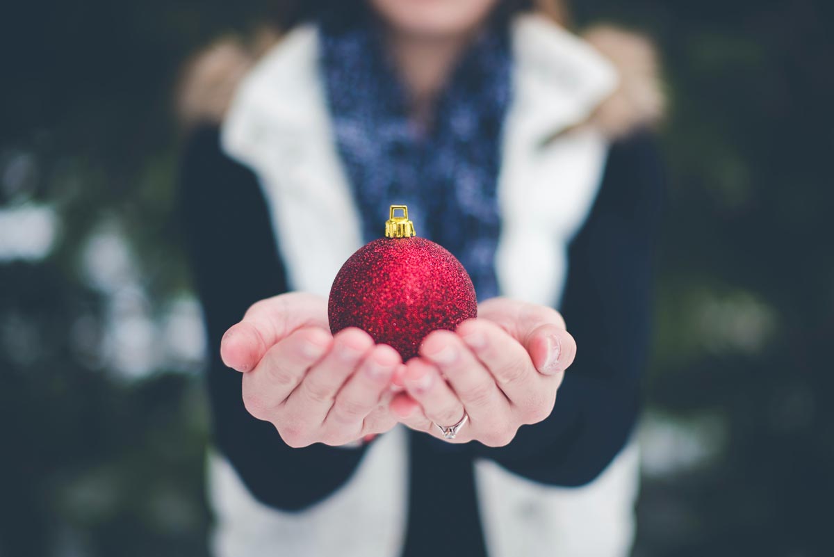 photo of a woman holding a christmas ball