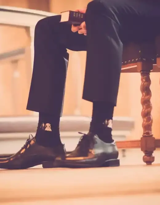 person sitting on a chair holding book
