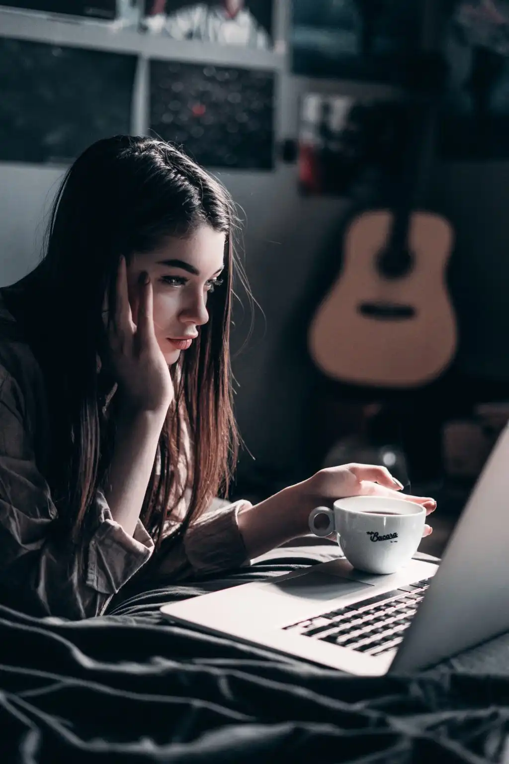 Woman attending a 12 step meeting for her drug rehab on her laptop from home