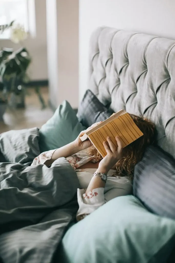 woman reading a book before sleeping