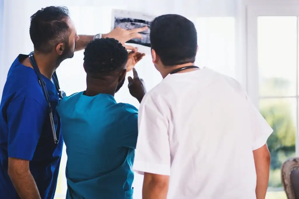 three doctors looking at scan result