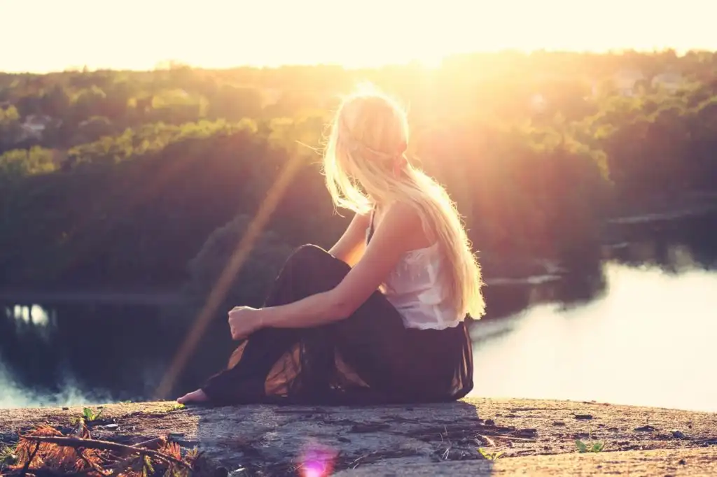 Woman overlooking lake and forest