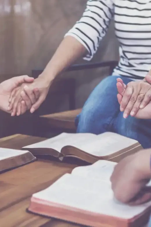 women and men praying together in Addiction Treatment Center