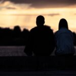 a couple having deep conversation during sunset