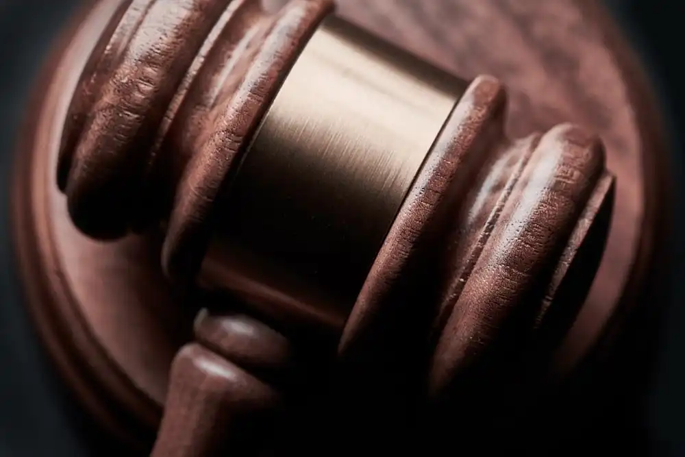 Gavel on black background being used in court
