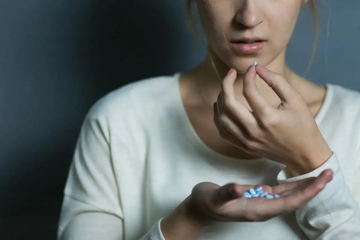 woman taking post-surgery pain medication