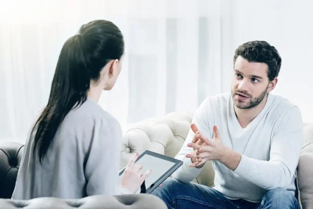 a male patient talking to his psychologist about his addiction
