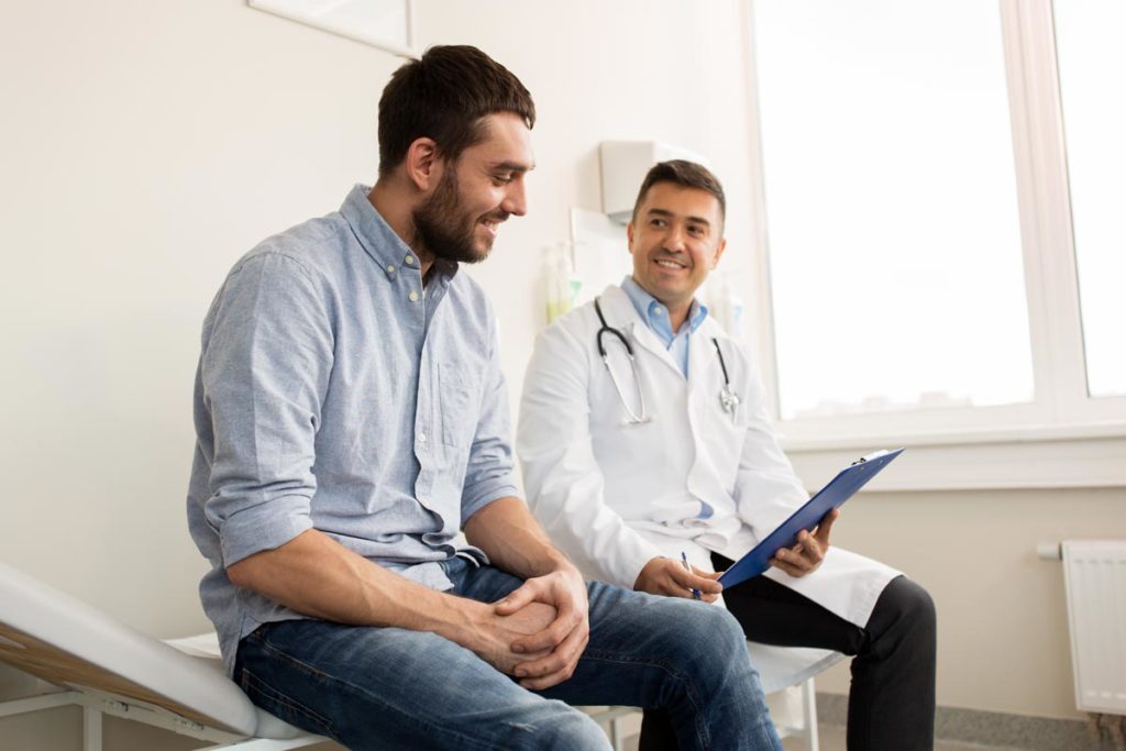 photo of a man together with a doctor during consultation
