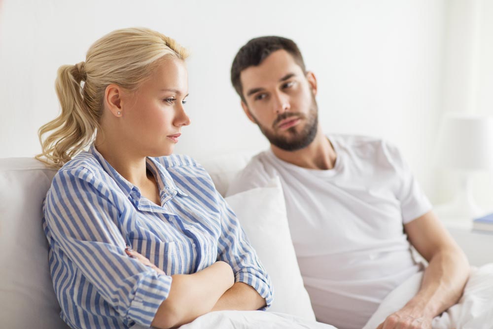 photo of unhappy couple discussing boundaries