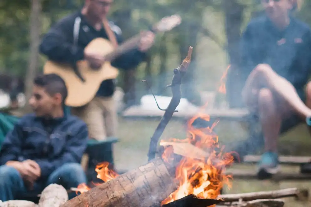 sober friends camping and playing the guitar