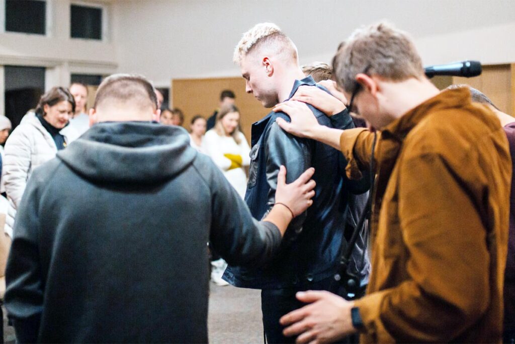 Christian Group praying for their brother in Christ