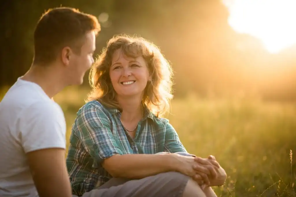 Mother with her adult son against nature background