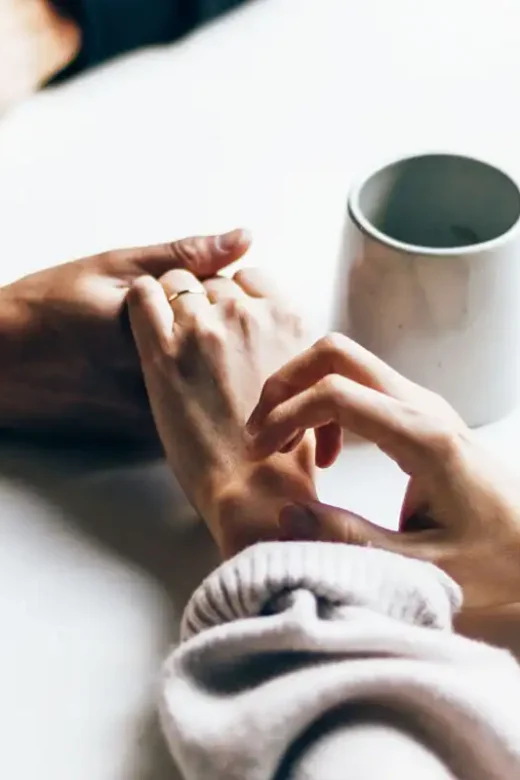 loved ones holding each other's hands discussing about going to addiction treatment center