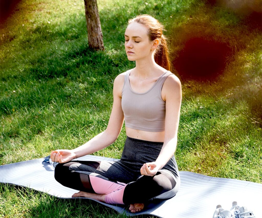 young woman doing yoga at 10 acre ranch