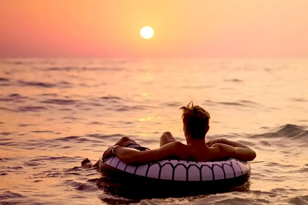 a young man taking a break floating in the ocean