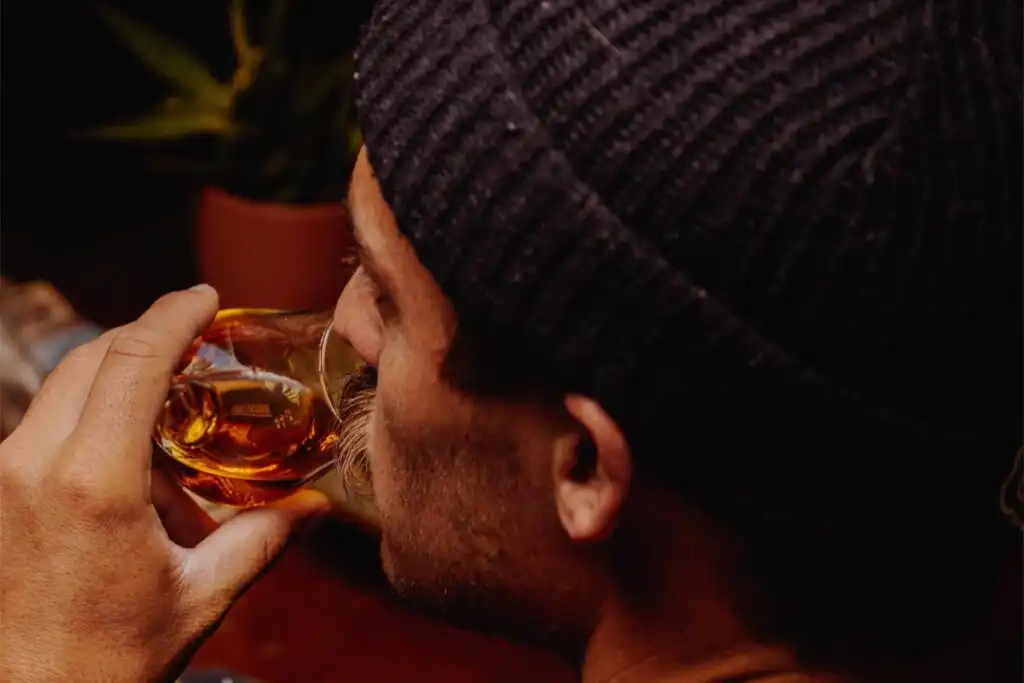 man drinking alcohol