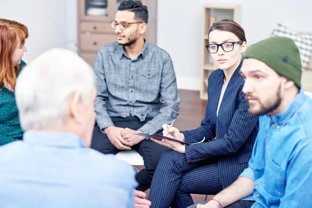 men and women during group therapy in addiction treatment center in Riverside CA