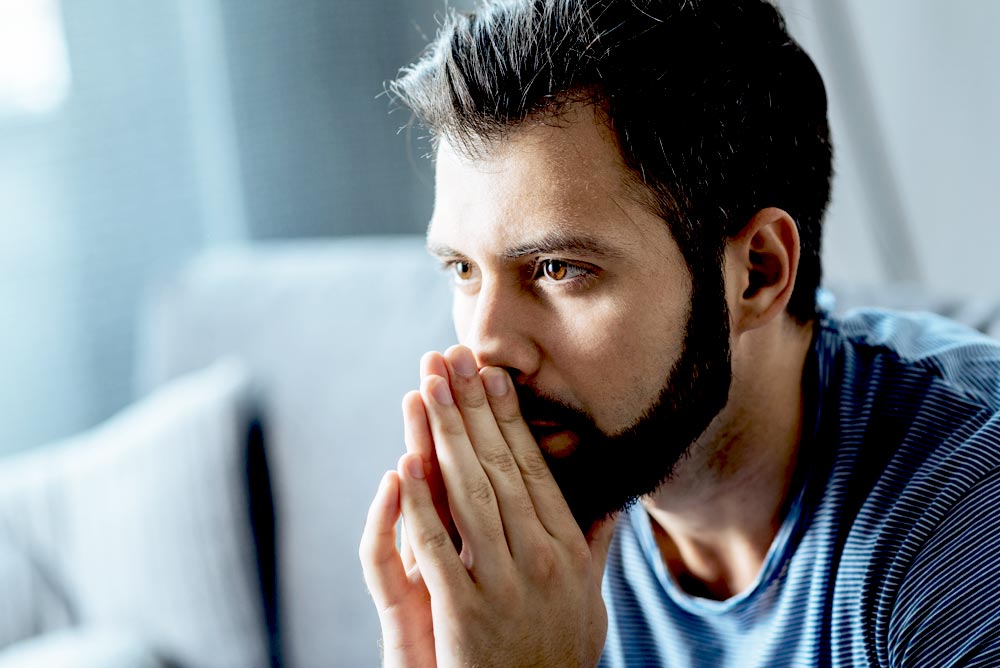 man thinking about getting help from his addiction
